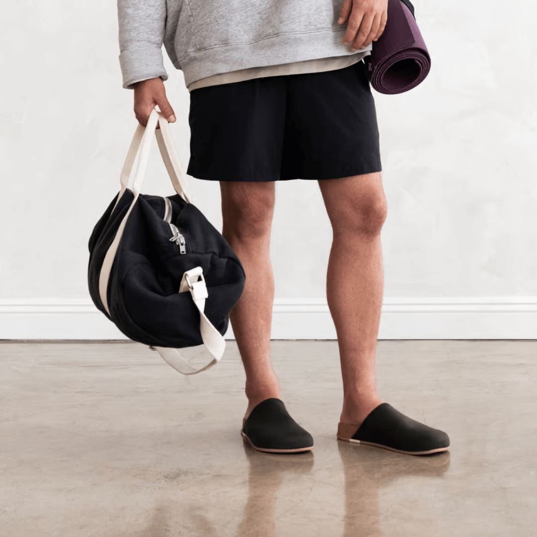 Man wearing olive Henning Classic Mules.