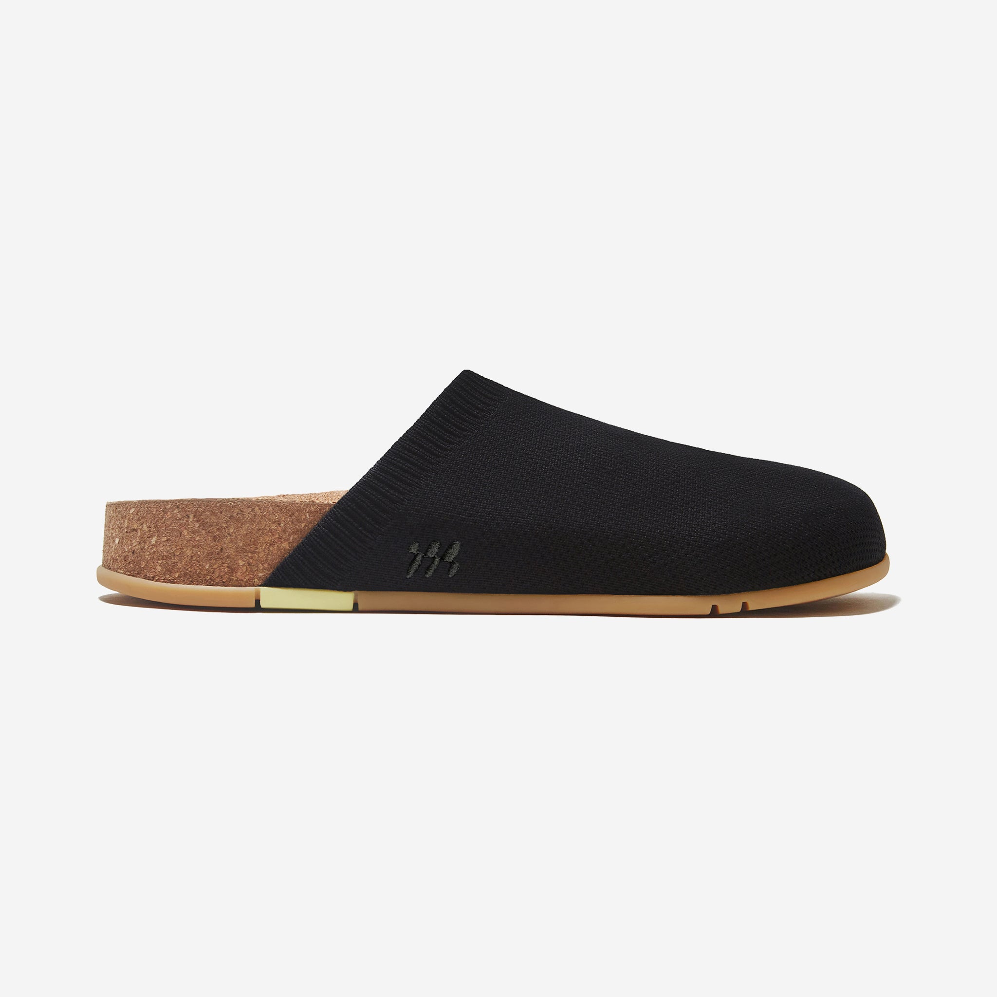 Black slipper with cork sole on a light gray background