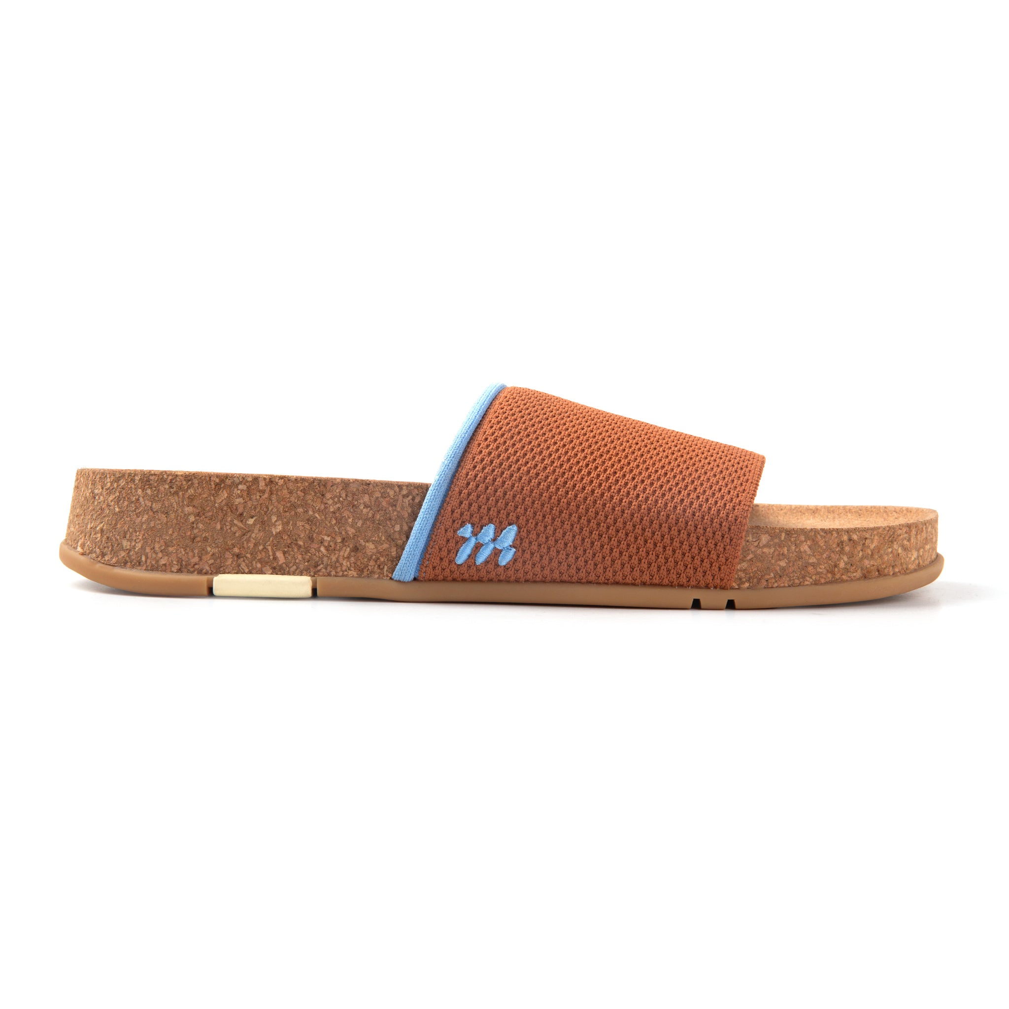 Brown slide sandal with cork sole on a white background