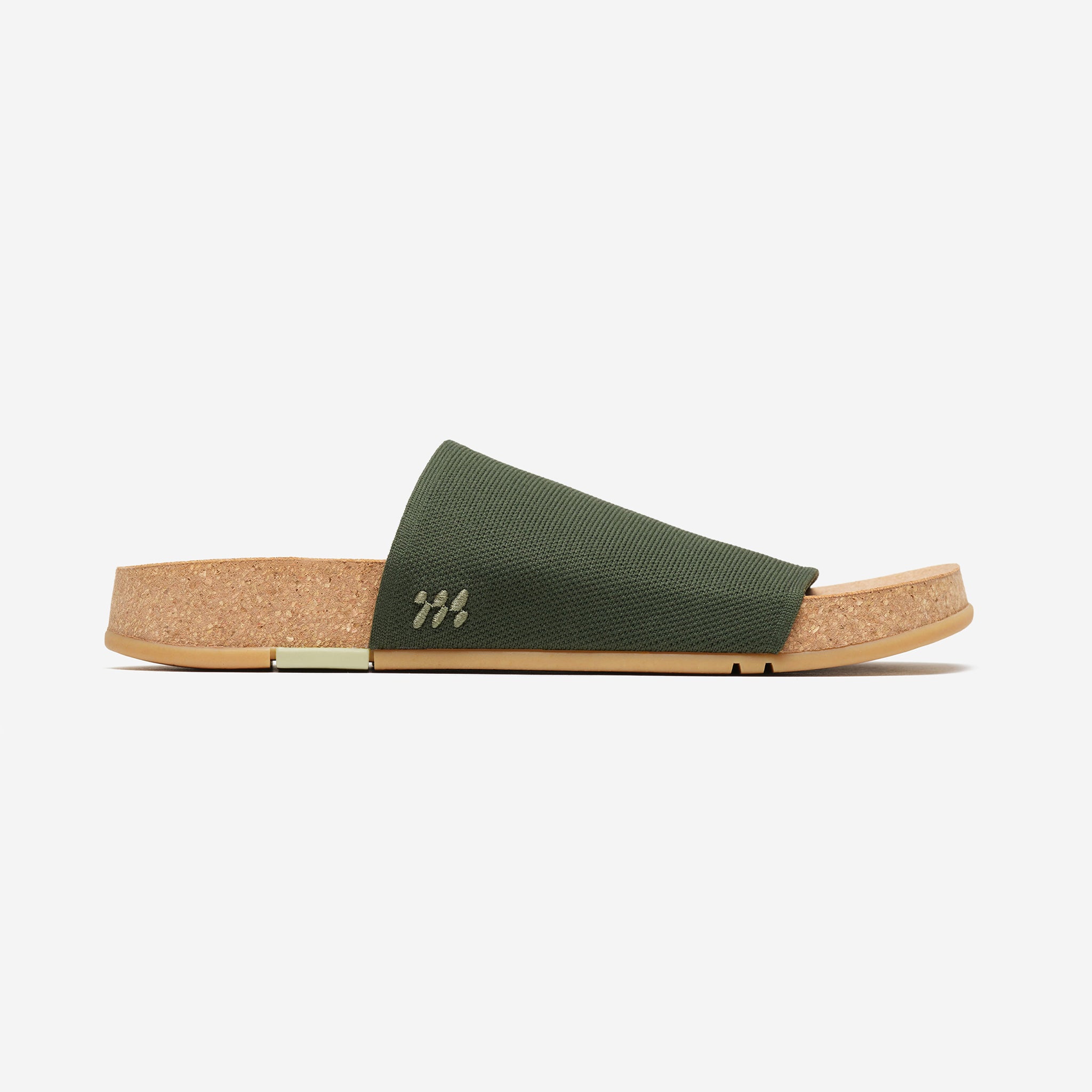 Green slide sandal with cork sole on a white background