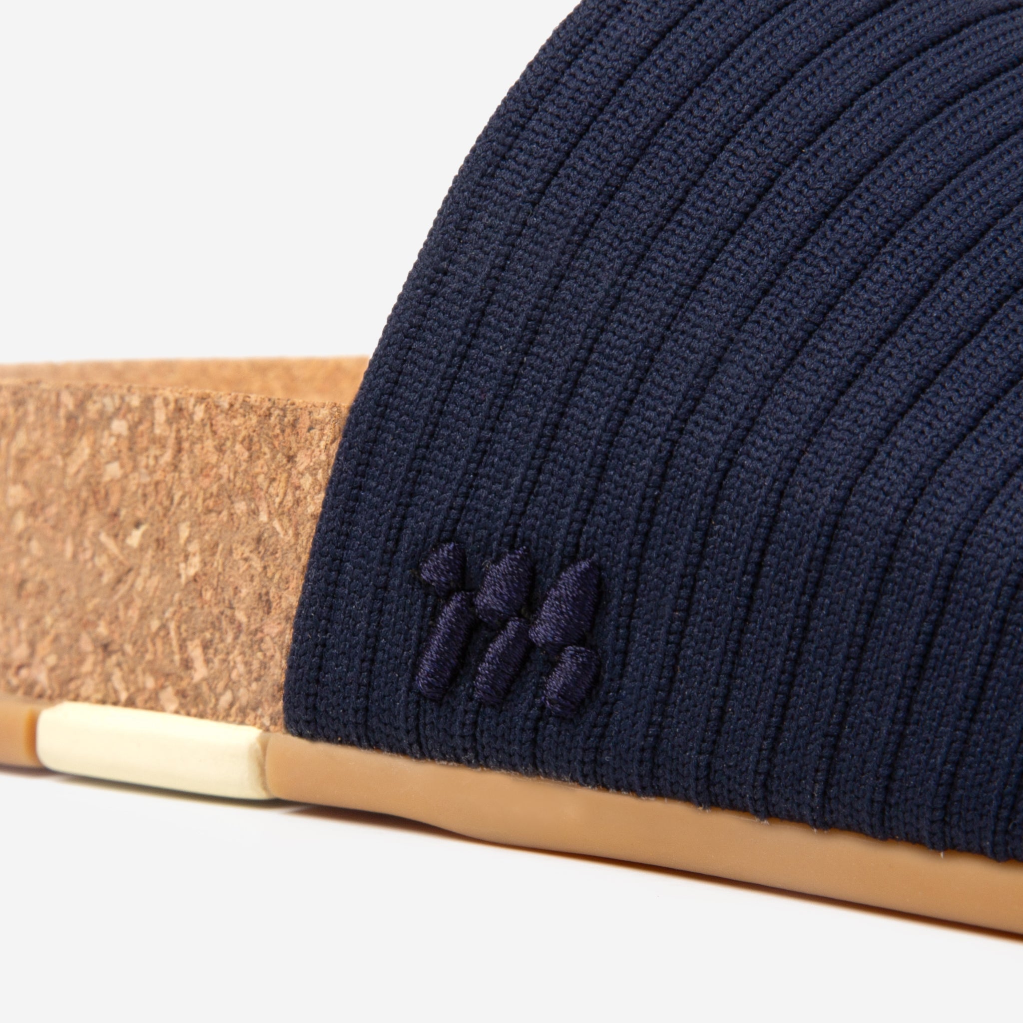 Navy blue beanie with a logo on a white background