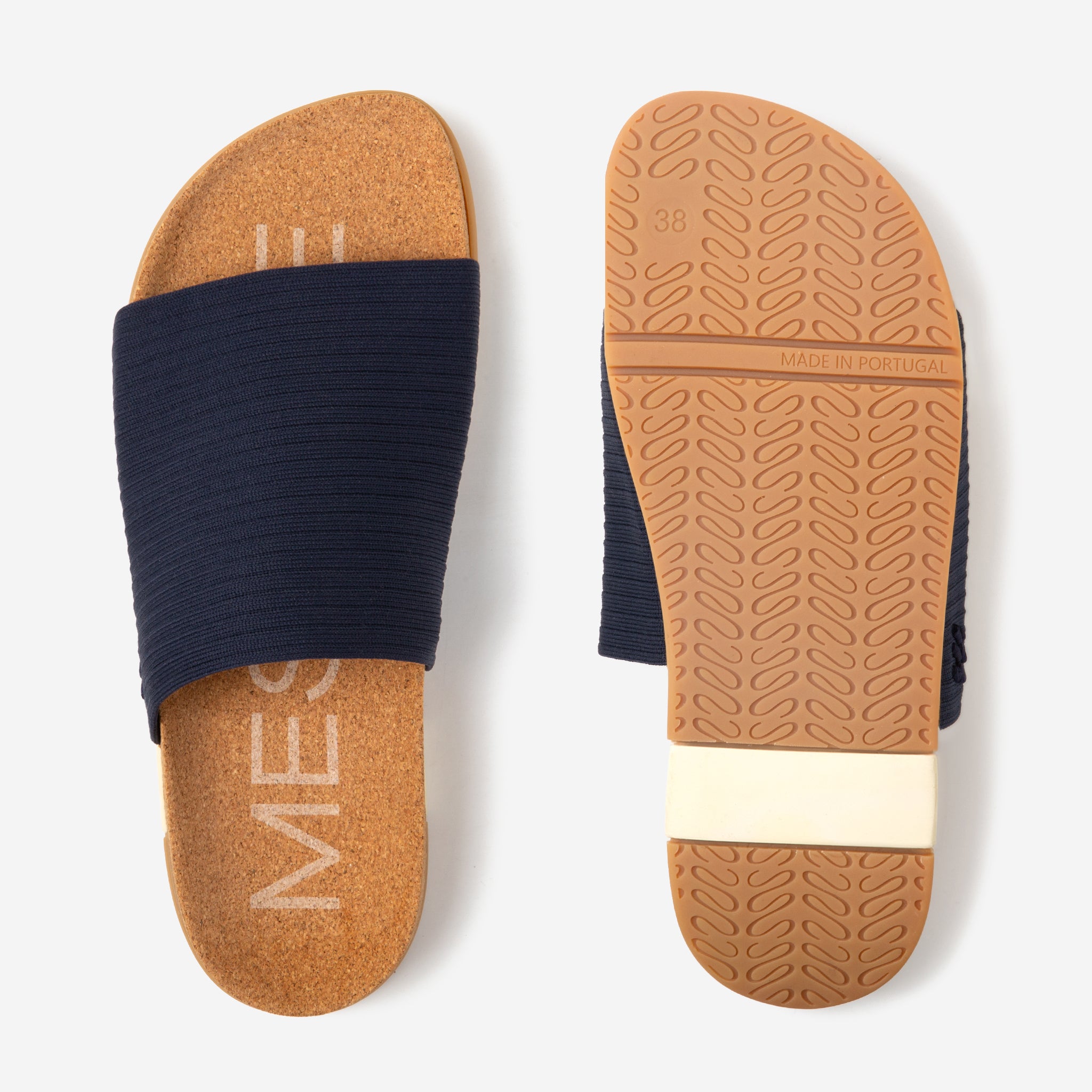 Navy slide sandal with brown sole on a white background