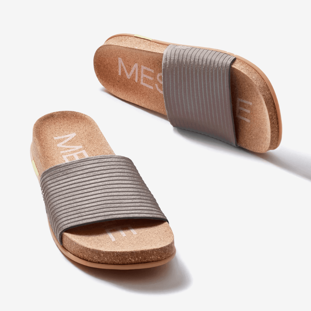 Showcasing a pair of stone Mullen Ripple Slides