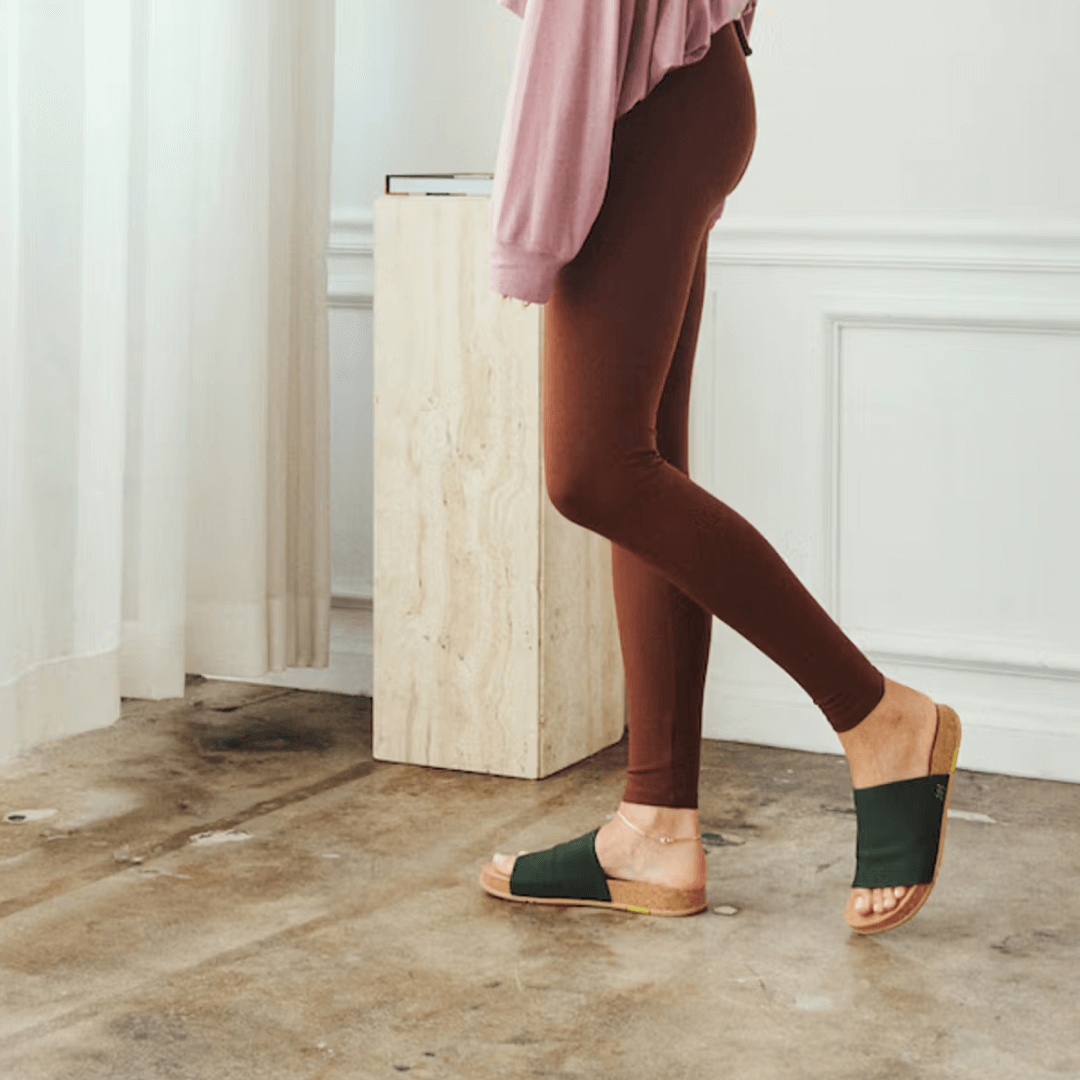 Woman walking in olive Shaw Classic Slides