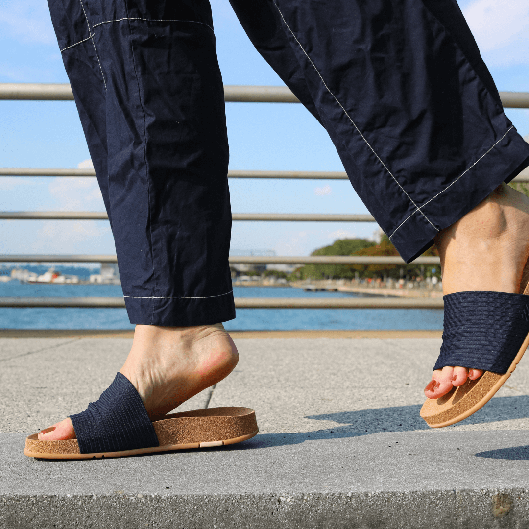 Woman walking in midnight Mullen Ripple Slides.
