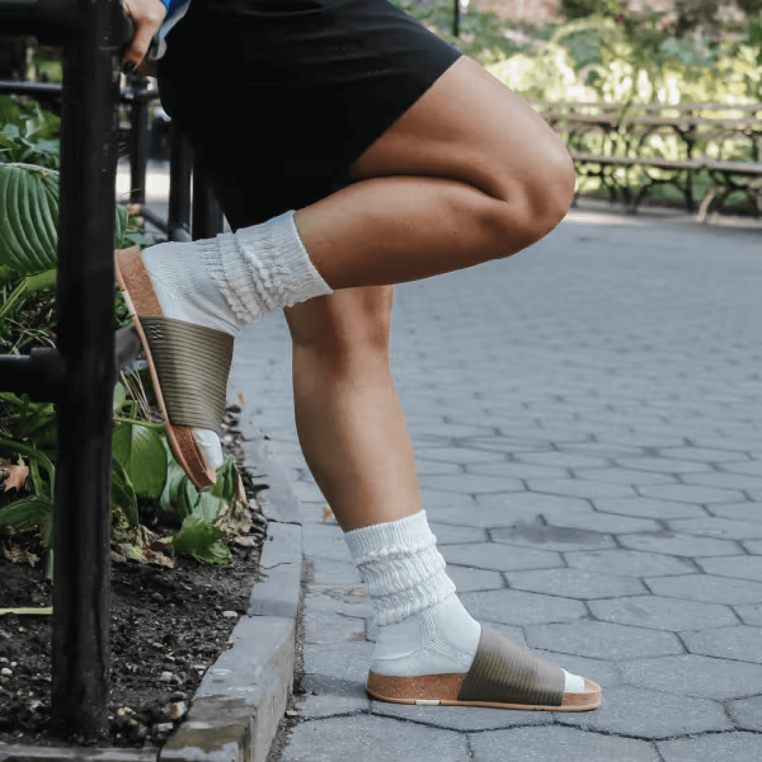 Woman wearing stone Shaw Ripple Slides with socks