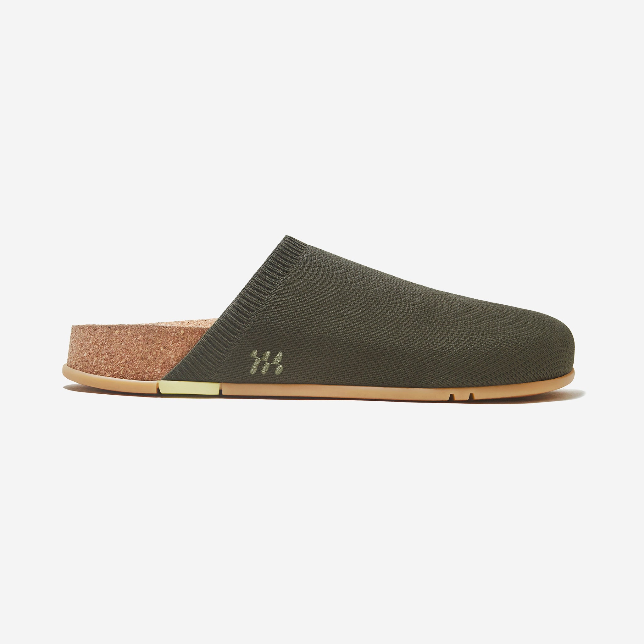 Green slipper with cork insole on a white background