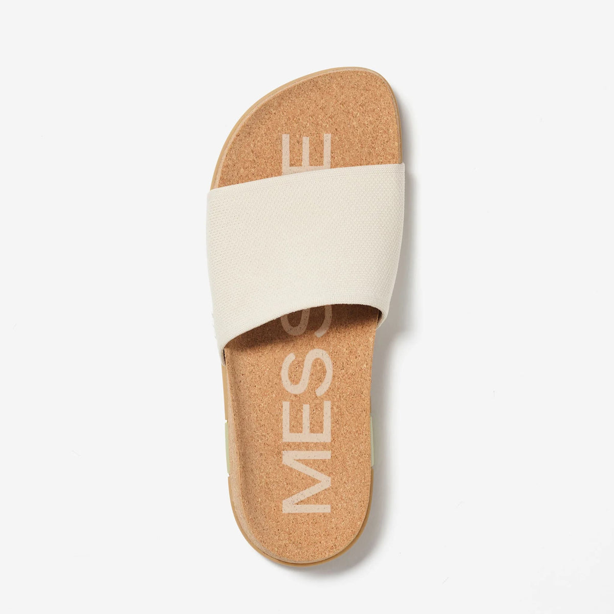 Cream slides viewed from above, featuring a woven knit strap and natural cork footbed.
