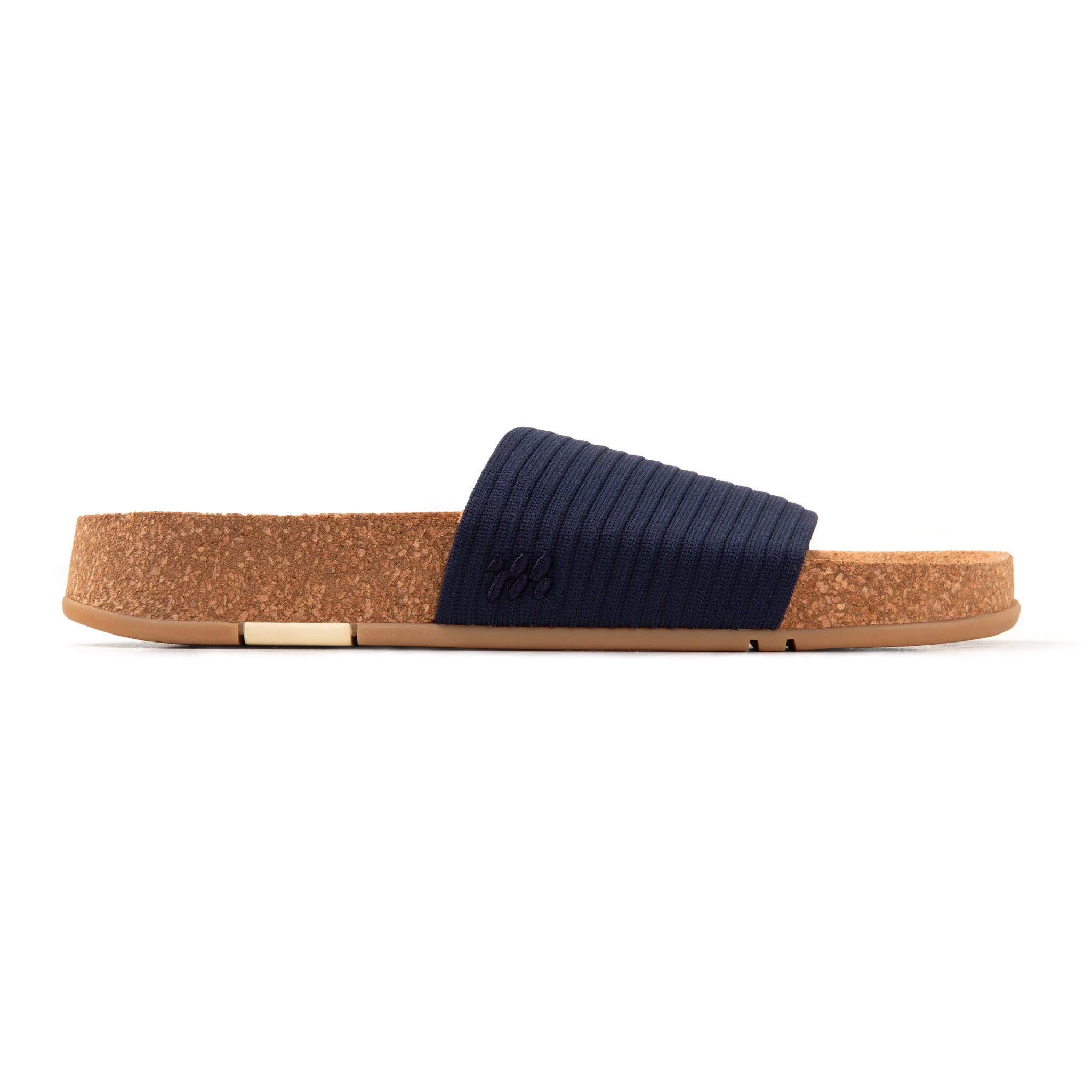 Navy slide sandal with cork sole on a white background
