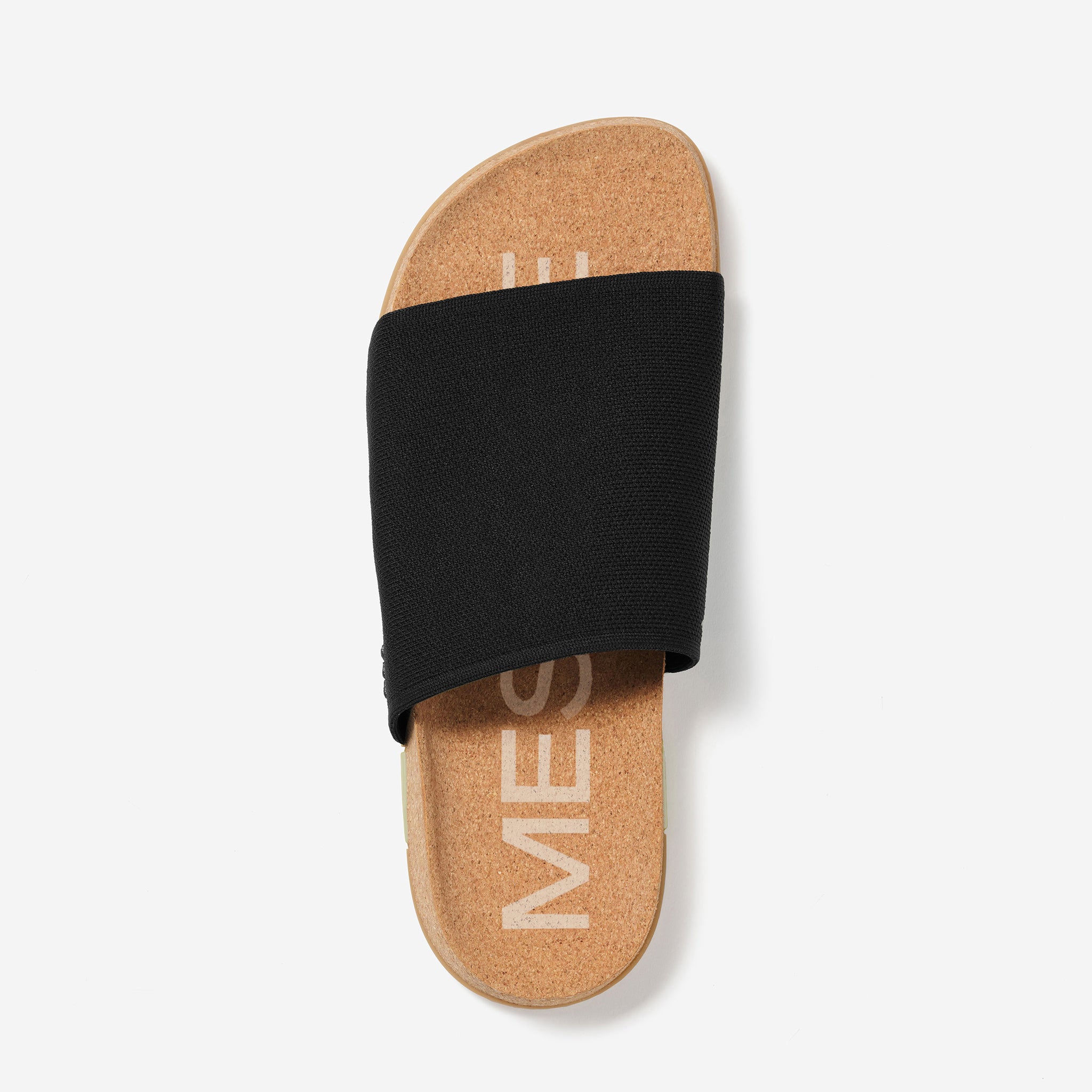 Black slide sandal with cork sole on a white background