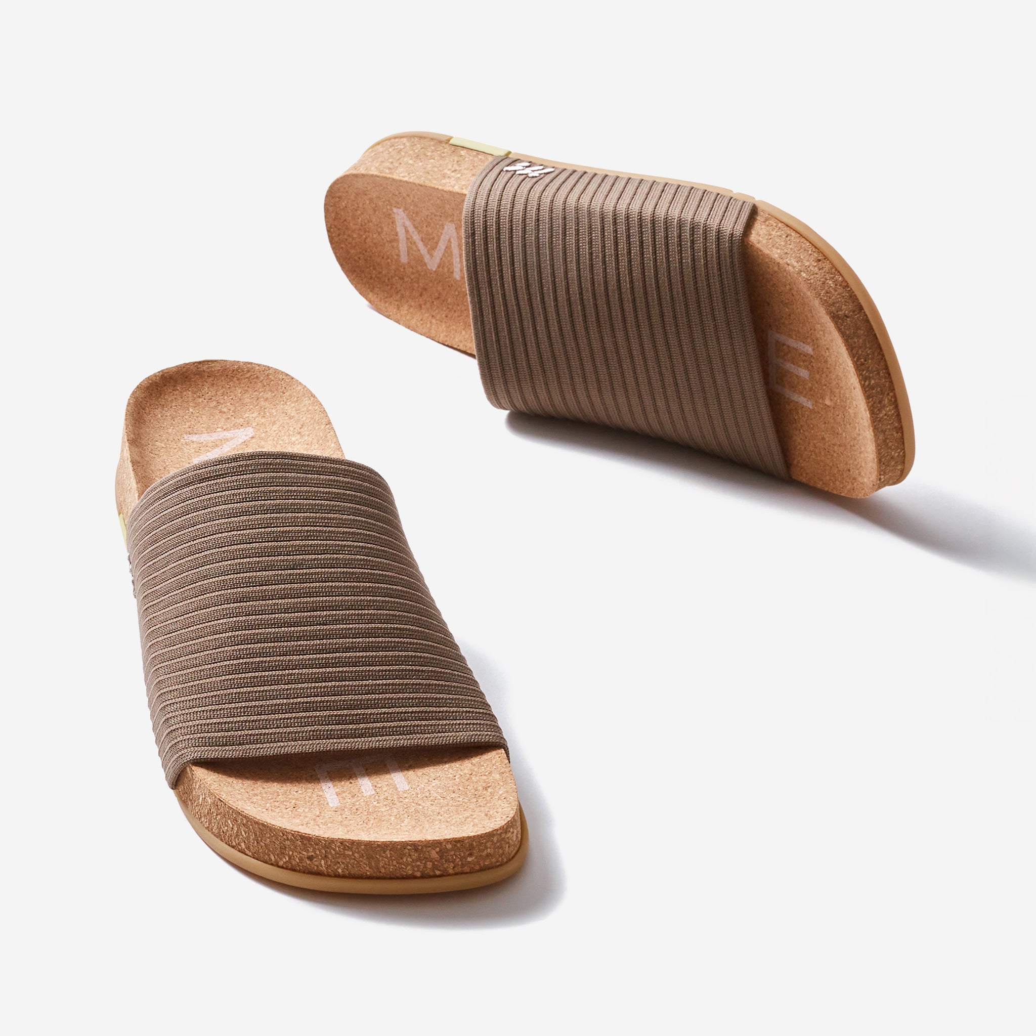 Pair of brown sandals with cork sole on a white background