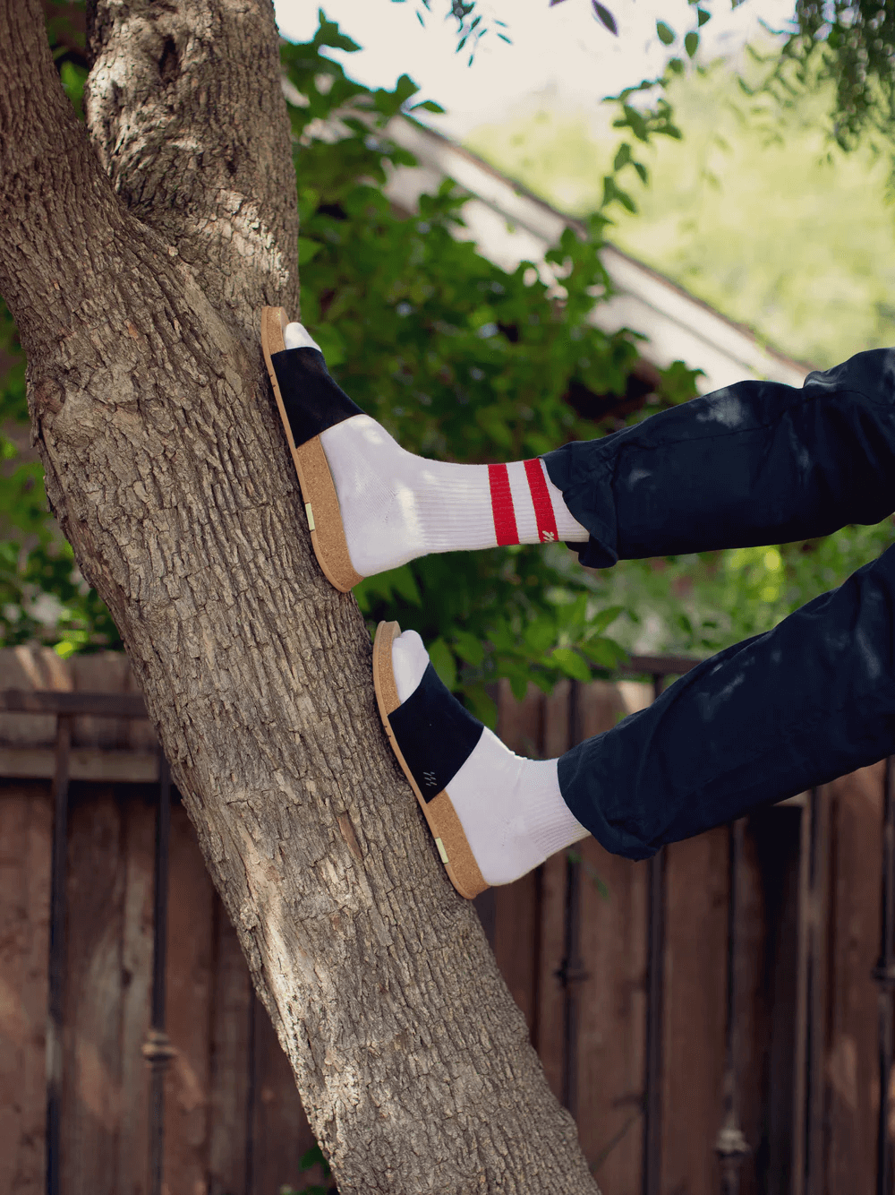 Person wearing Message Socks paired with black Mullen Classic Slides 